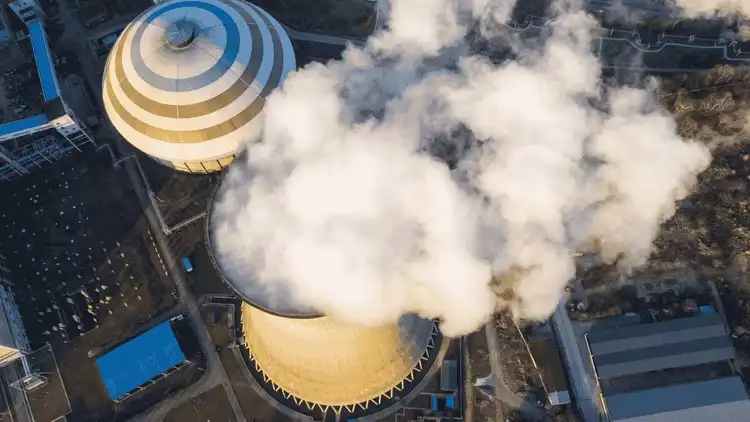 Steam power plant with cooling towers and chimney illustrating the working principle of steam power plant